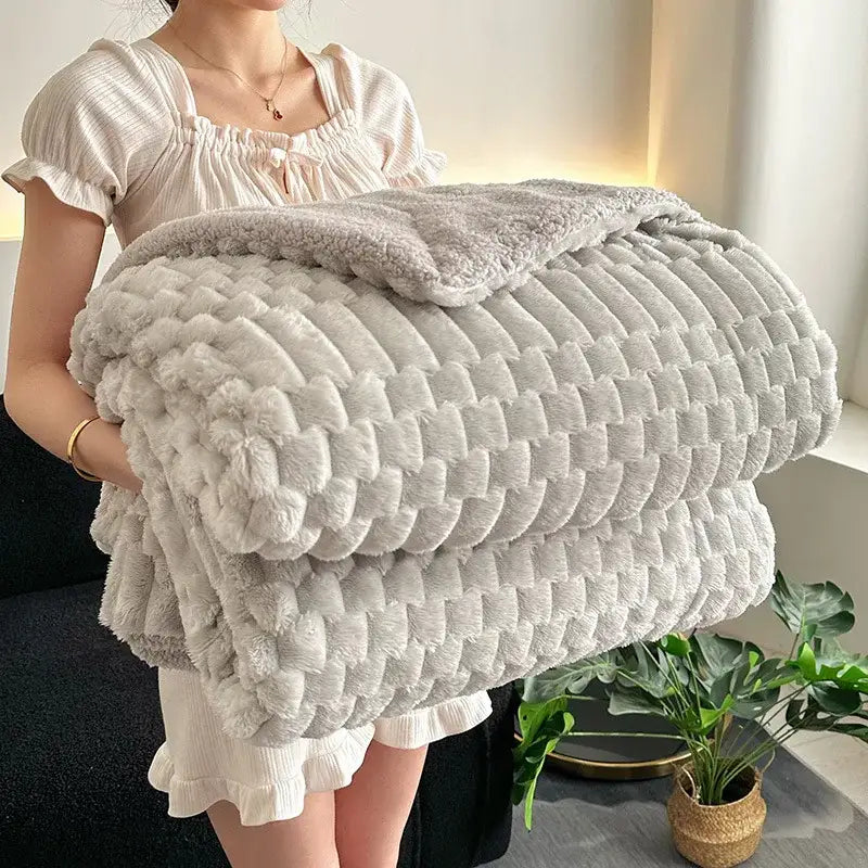 A light gray lamb plush throw blanket with a soft fuzzy fleece surface and textured quilted pattern for bedroom use