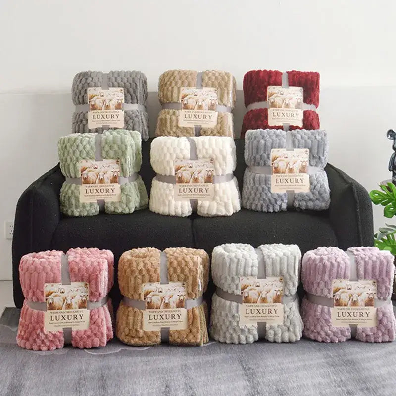 A plush throw blanket in soft pastel and earthy tones made of double layer lamb plush fleece for bedroom use