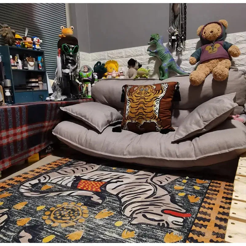 Gray futon with a brown tiger-patterned pillow featuring black tassels in a double tiger bohemian moroccan living room decor