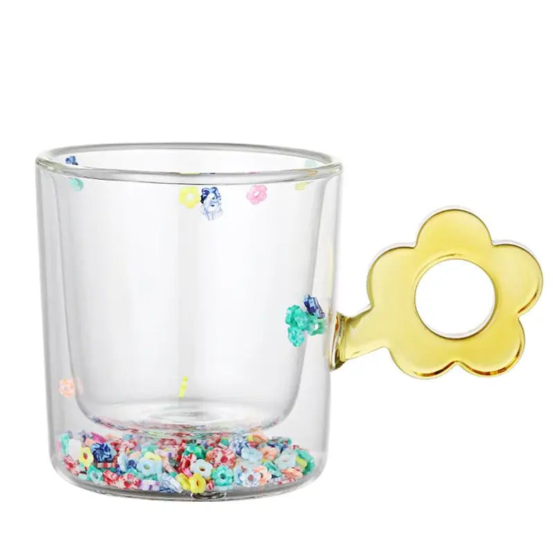 Clear double wall glass mug with yellow flower handle and colorful glitter flowers inside for kitchen and dining room