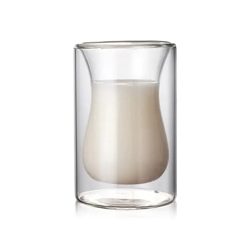 Clear double walled glass mug with curved teardrop interior holding milk from drinkware collection for enhanced drinking experience