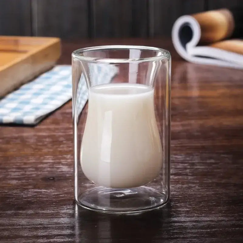 Clear double-walled glass mug filled with white liquid from drinkware collection enhancing drinking experience