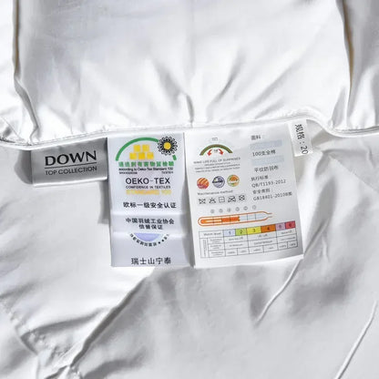 White down duvet with silver black labels showing down top collection branding oeko-tex certification and care instructions
