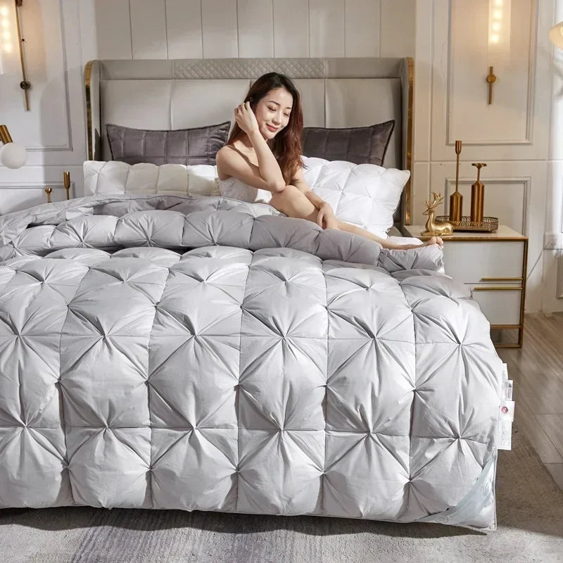 A plush light gray down duvet with diamond stitching made of 95 white goose down for warm five-star hotel use