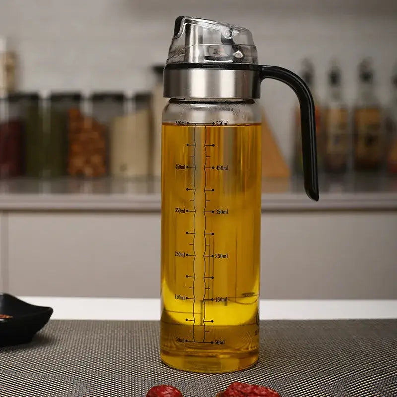Durable automatic oil clear glass dispenser with stainless steel lid and black handle marked with milliliter measurements