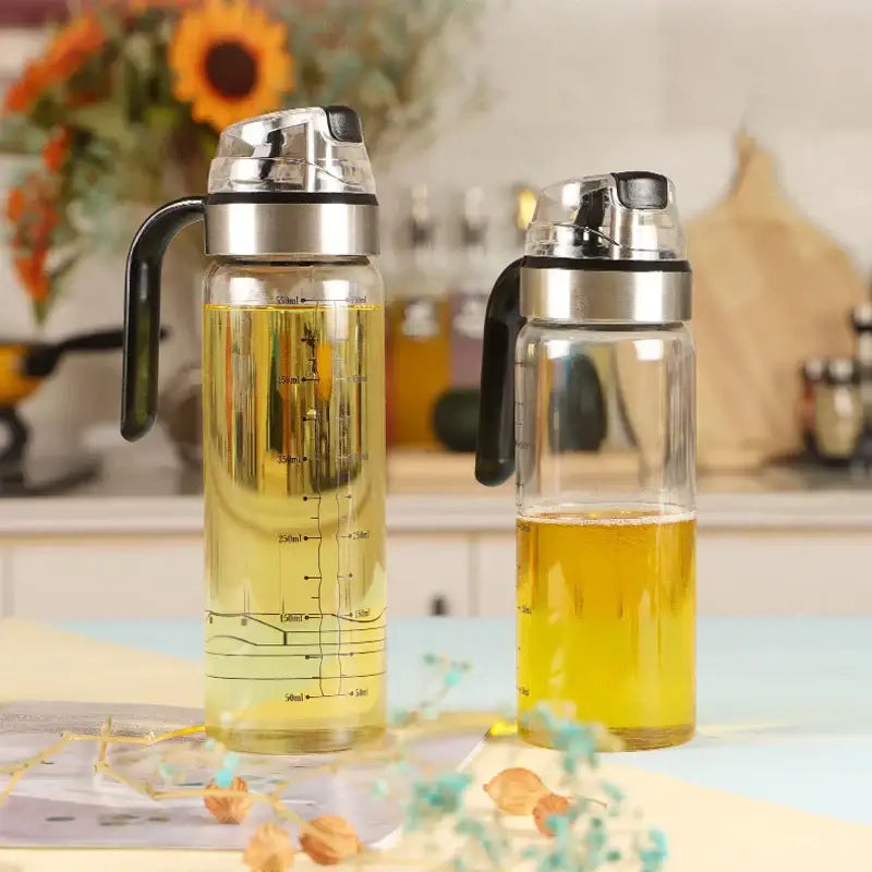 Durable automatic oil bottle set in red and gold featuring a clear glass dispenser with measurement markings and silver lid