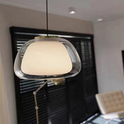 Modern pendant light hanging in a room with a blurred background