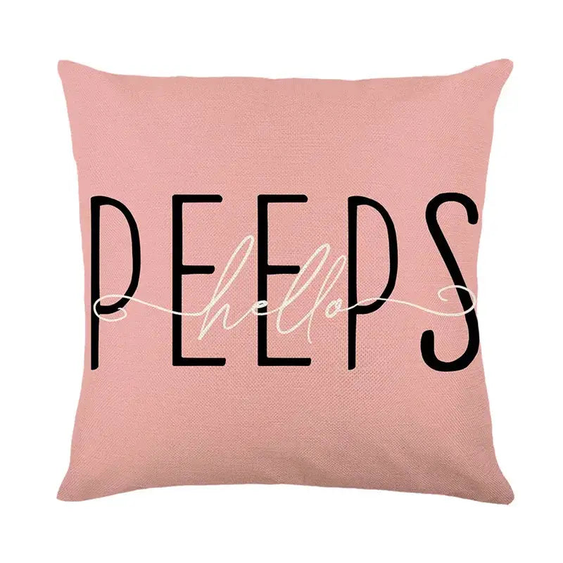 Pink easter bunny rabbit linen cushion cover with peeps hello printed in black and white script for living room