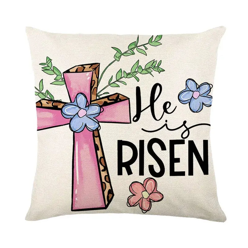 Beige linen cushion cover featuring a pink cross with leopard print accents blue and pink flowers and he is risen text for easter bunny rabbit decor