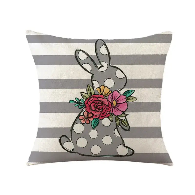 Gray polka-dotted easter bunny rabbit linen cushion cover with colorful floral design on a striped living room pillow