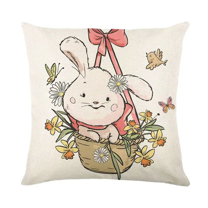Beige linen cushion cover featuring an easter bunny rabbit in a woven basket with daisies and a pink ribbon bow