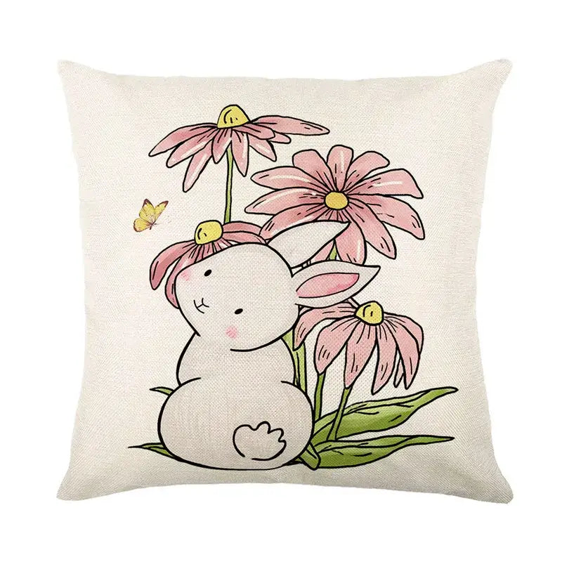 A soft beige linen cushion cover featuring an easter bunny rabbit among pink coneflowers and a yellow butterfly