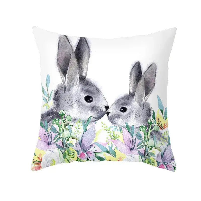 White throw pillow featuring a watercolor easter rabbit and eggs pillowcase with pastel floral home decor design