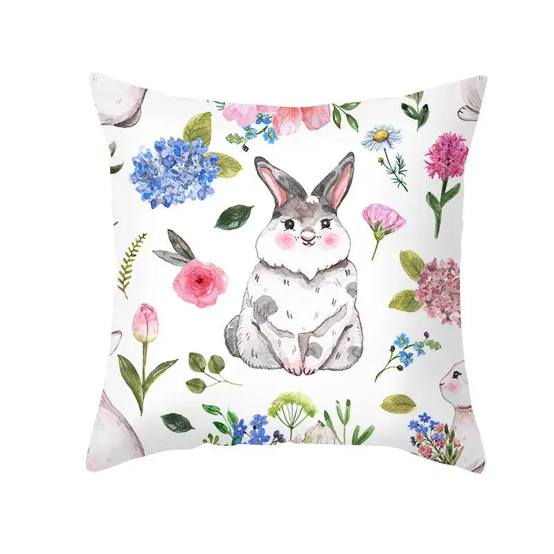 A white cushion featuring a watercolor easter rabbit and eggs pillowcase with floral home decor design