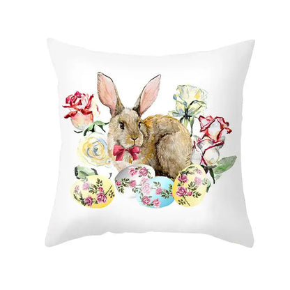 White throw pillow featuring a watercolor easter rabbit with pink bow surrounded by pastel eggs for home decor