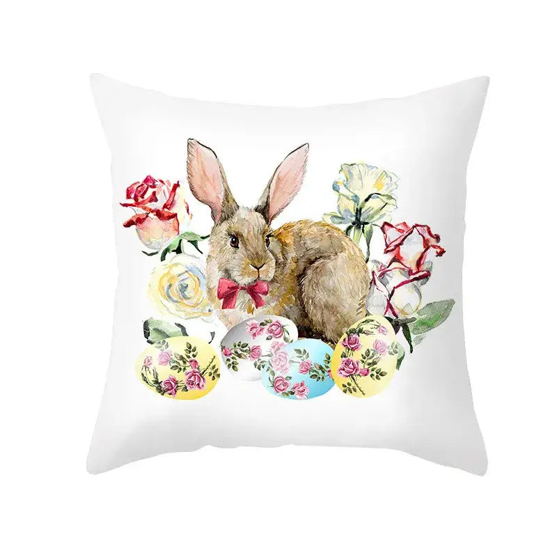 White throw pillow featuring a watercolor easter rabbit with pink bow surrounded by pastel eggs for home decor