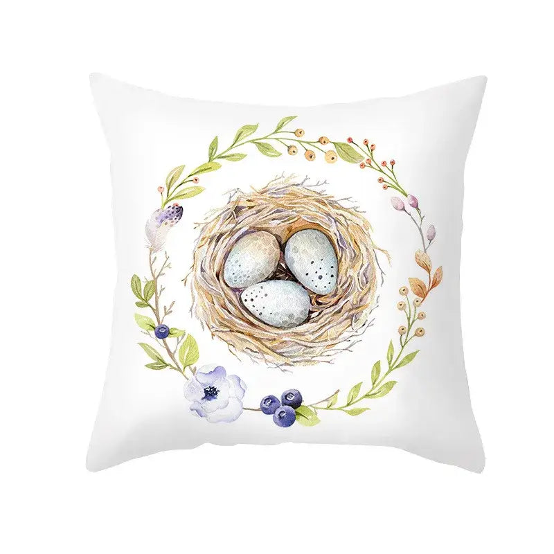 White throw pillow with watercolor bird nest and eggs surrounded by green leaves for easter rabbit eggs pillowcase home decor