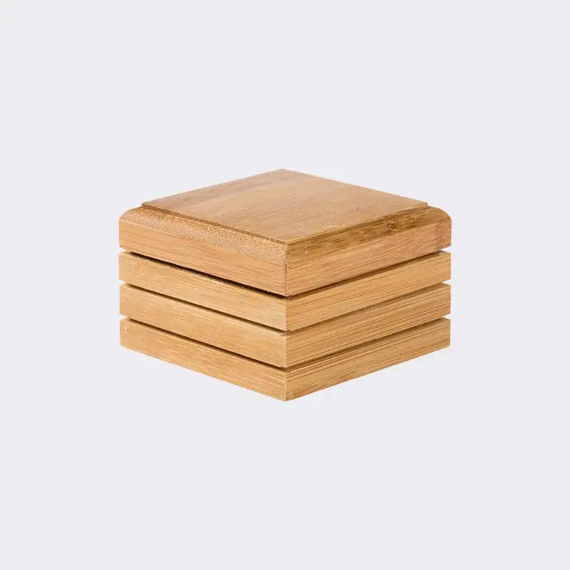 Stack of four light brown bamboo soap dish coasters with wood grain and beveled edges for eco-friendly bathroom storage