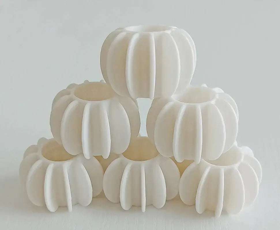 White ribbed ceramic candle holders with glossy finish complement eco-friendly laundry washing starburst balls gray and white set