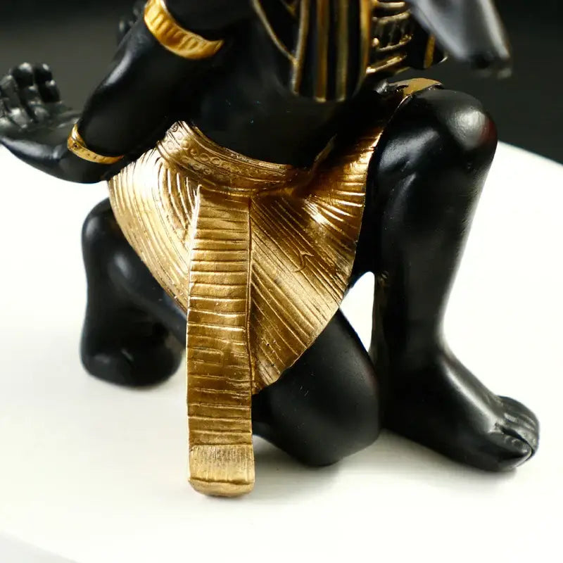 Black and gold resin egyptian dog god wine rack with detailed hieroglyphic headdress and textured golden kilt for dining room decor