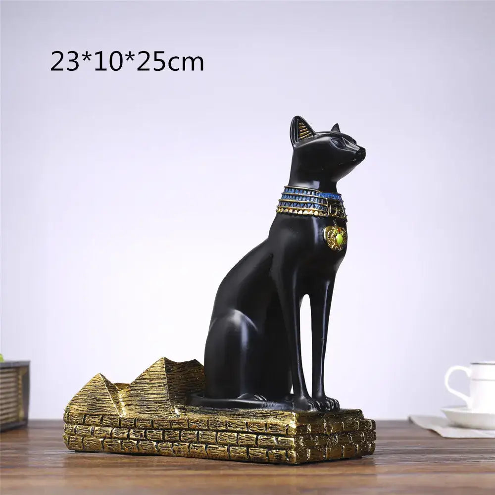 Black resin egyptian cat wine bottle holder with gold and blue collar seated on a golden pyramid base for dining decor