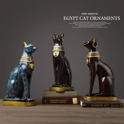 Three egyptian cat resin figurines with glossy finish and gold trim featuring green heart pendants for home decor