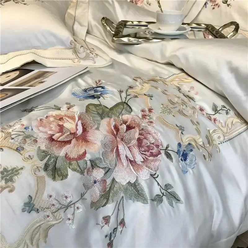 Elegant ivory satin egyptian cotton white embroidery bedding set with floral embroidery and gold-toned ornamental framing
