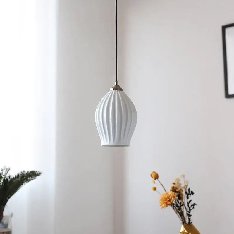 White elegance ribbed ceramic pendant light with vertical ridges and brass-colored metal fixture for dining room lighting