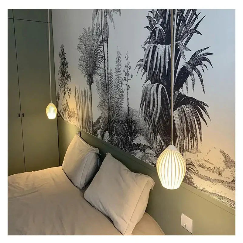 Two warm white and gold elegance ribbed ceramic pendant lights hang from the bedroom ceiling