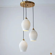 Elegance ribbed ceramic pendant lights in white with gold-toned metal accents and black cords for dining room lighting
