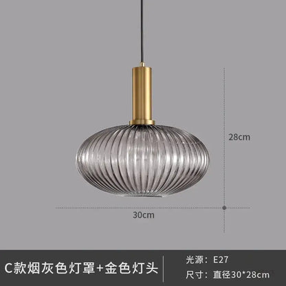 Elegant glass pendant lights with smoked gray ribbed glass and polished gold metal fixture for dining room lighting