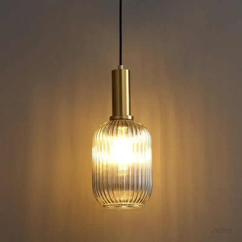 Elegant amber warm-toned glass pendant light with ribbed shade and brass finish ideal for dining room pendant lights