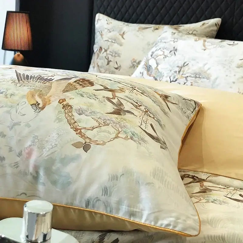 Cream-colored silk pillowcase with delicate bird and branch pattern and gold piping in decorbites colorful egyptian cotton bedding set