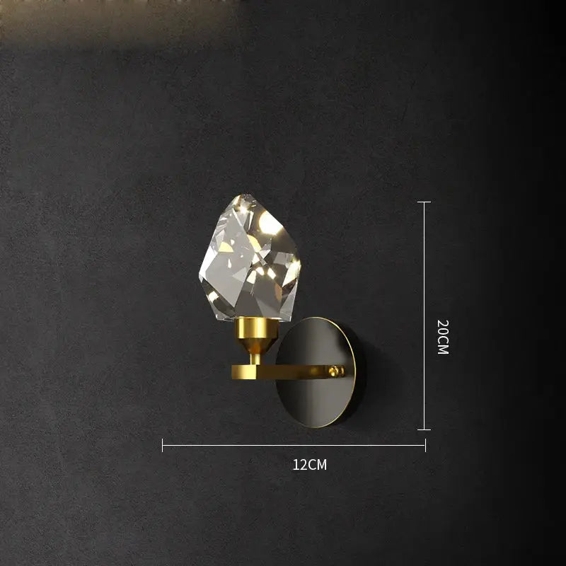 A sleek gold-toned wall sconce with a faceted crystal gemstone for elegant bedroom decorbites crystal stone wall lamp