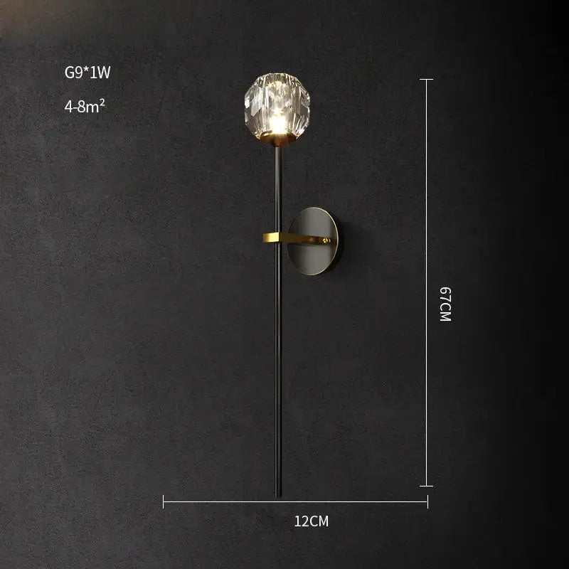 Elegant black and gold decorbites crystal stone wall sconce with faceted globe emitting warm light for bedroom use