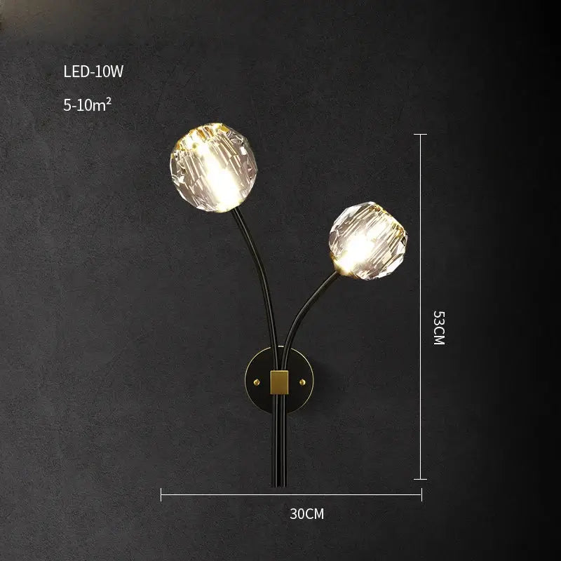 Elegant black wall sconce with two faceted crystal globe lights and a gold-toned circular base decorbites crystal stone wall lamp