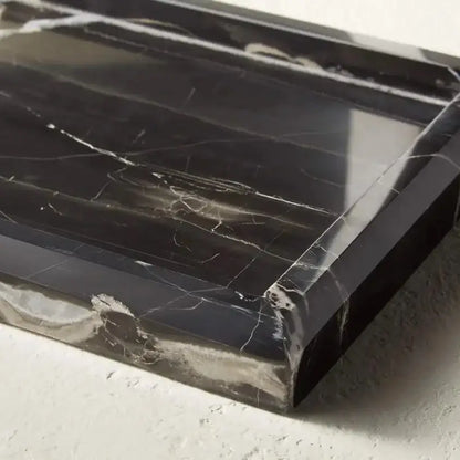 Elegant black and white afralia marble tray with polished surface and subtle white veining for bedroom decor