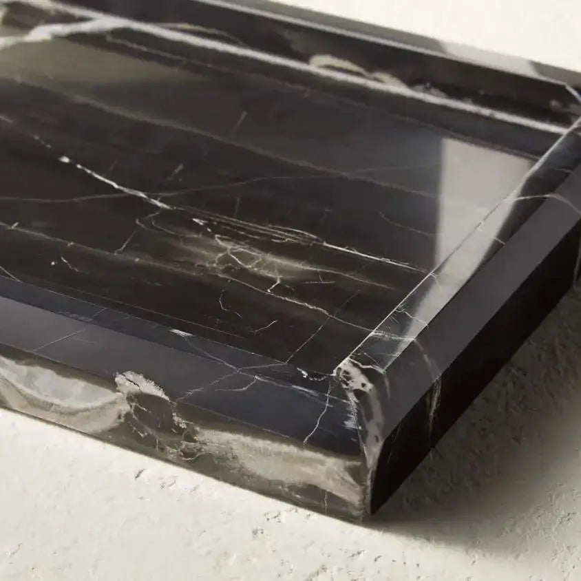 Elegant black and white afralia marble tray with polished surface and subtle white veining for bedroom decor