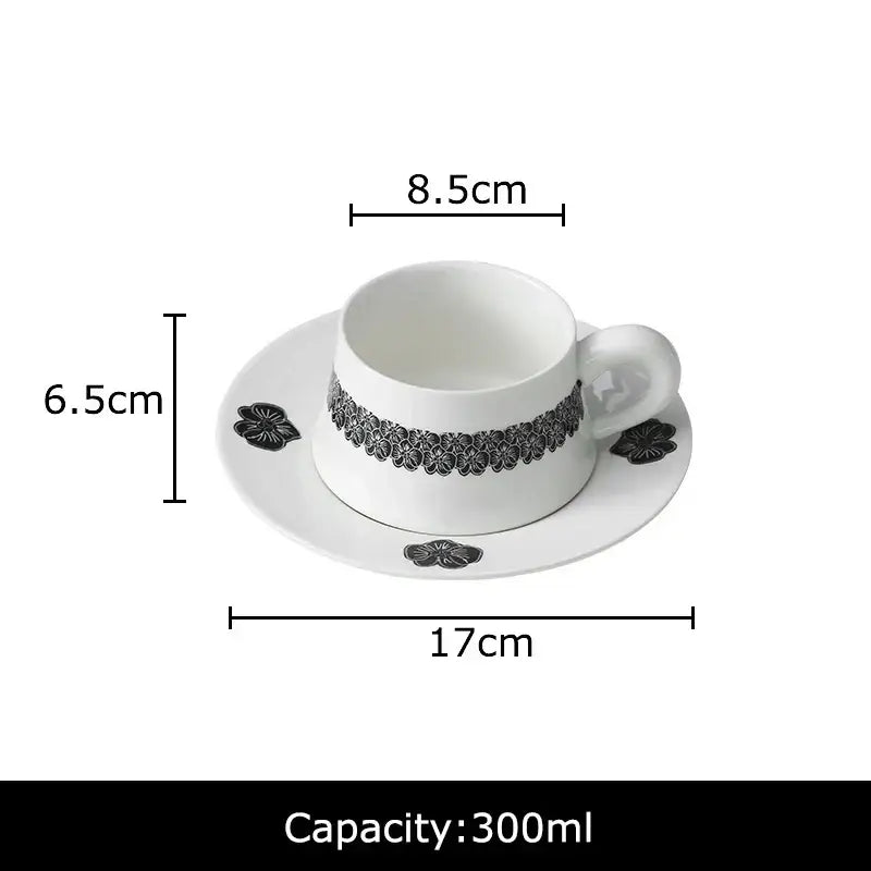 Elegant black and white floral porcelain cup and saucer set featuring delicate patterns for dining room use