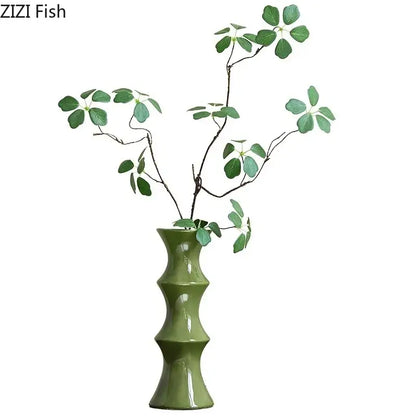 Elegant olive green bamboo shape ceramic vase with segmented design holds green leafy branches for living room decorbites