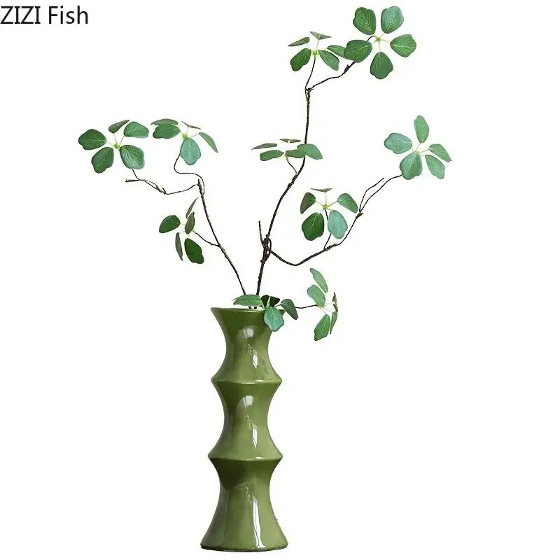 Elegant olive green bamboo shape ceramic vase with segmented design holds green leafy branches for living room decorbites