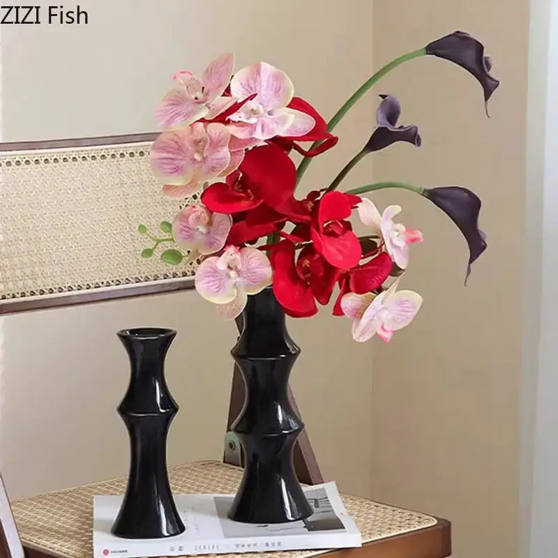 Elegant black bamboo shape ceramic vase with sleek segmented design holding vibrant orchids and dark calla lilies decorbites bamboo shape