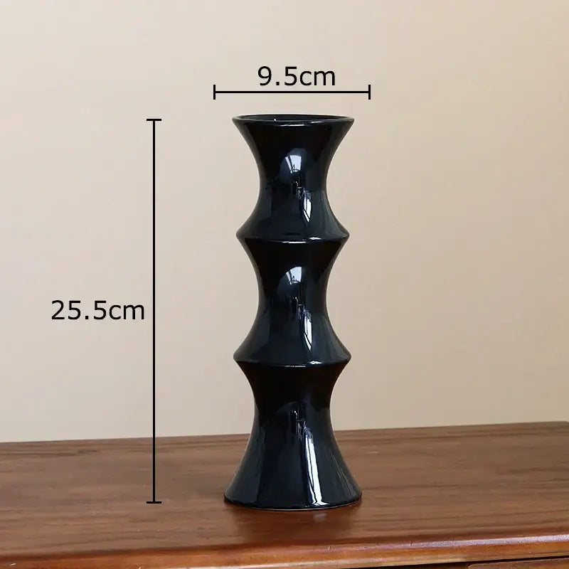 A sleek glossy black bamboo shape ceramic vase with a tiered hourglass silhouette for living room decorbites decor