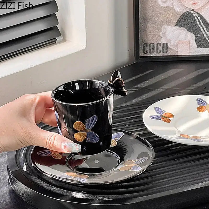 Elegant black ceramic tea cup and saucer set with butterfly handle and colorful painted butterflies for dining room use