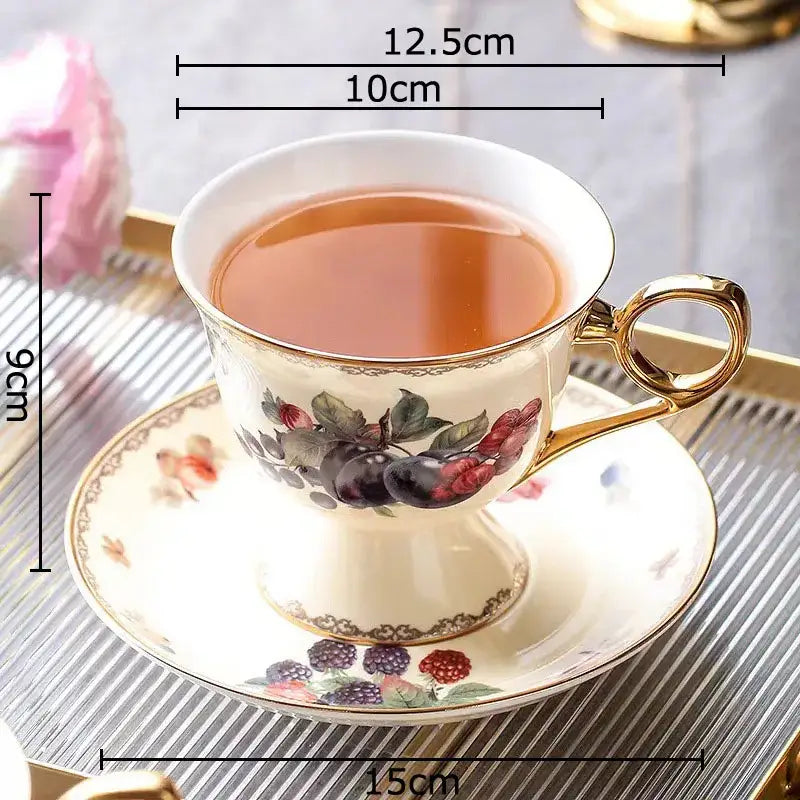 Elegant cream-colored porcelain teacup with gold trim and hand-painted berry decorbites fruits pattern ceramic saucer