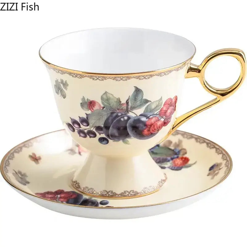 Cream-colored porcelain teacup and saucer with gold trim featuring a delicate decorbites fruits pattern ceramic design