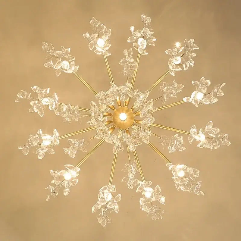 Gold-toned elegant black crystal chandelier with crystal flower accents and multiple illuminated bulbs for dining room