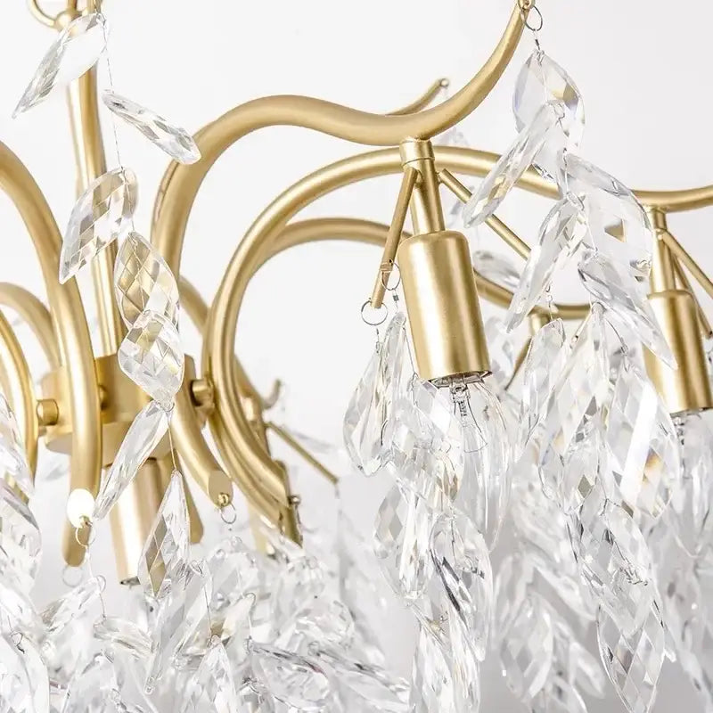Elegant black crystal chandelier with gold-toned wrought iron frame and cascading clear crystal leaf-shaped pendants