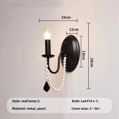 Elegant black crystal chandelier pendant light featuring a black metal frame with candle-style bulb and pearl beads