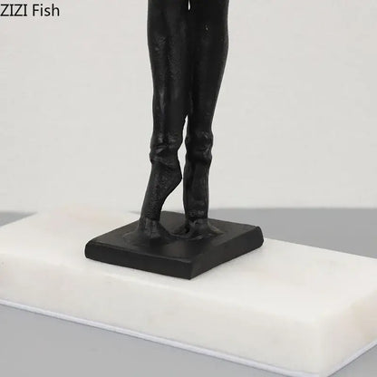 Elegant black sculpted ballerina sculpture of legs in formal attire on white marble plinth with gold accents bedroom decor